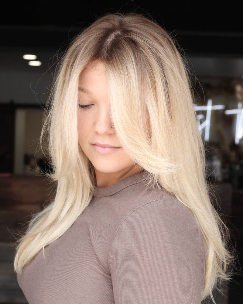 Client with bright blonde color and a soft shadow root by Hope