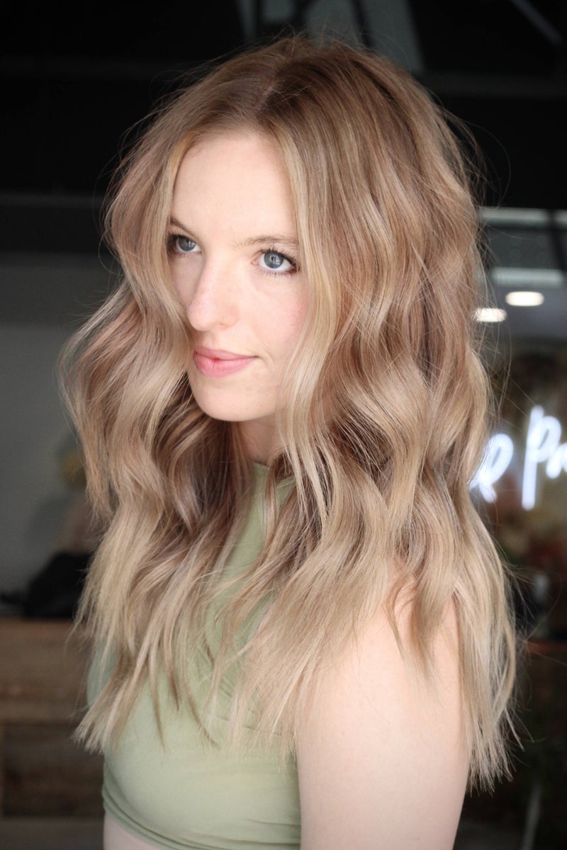 Client with soft, wavy lived-in blonde color by Hope