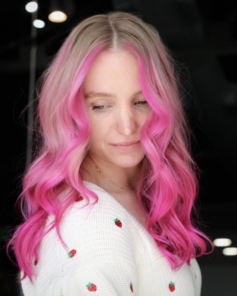 Client with vivid pink waves over a blonde base by Hope